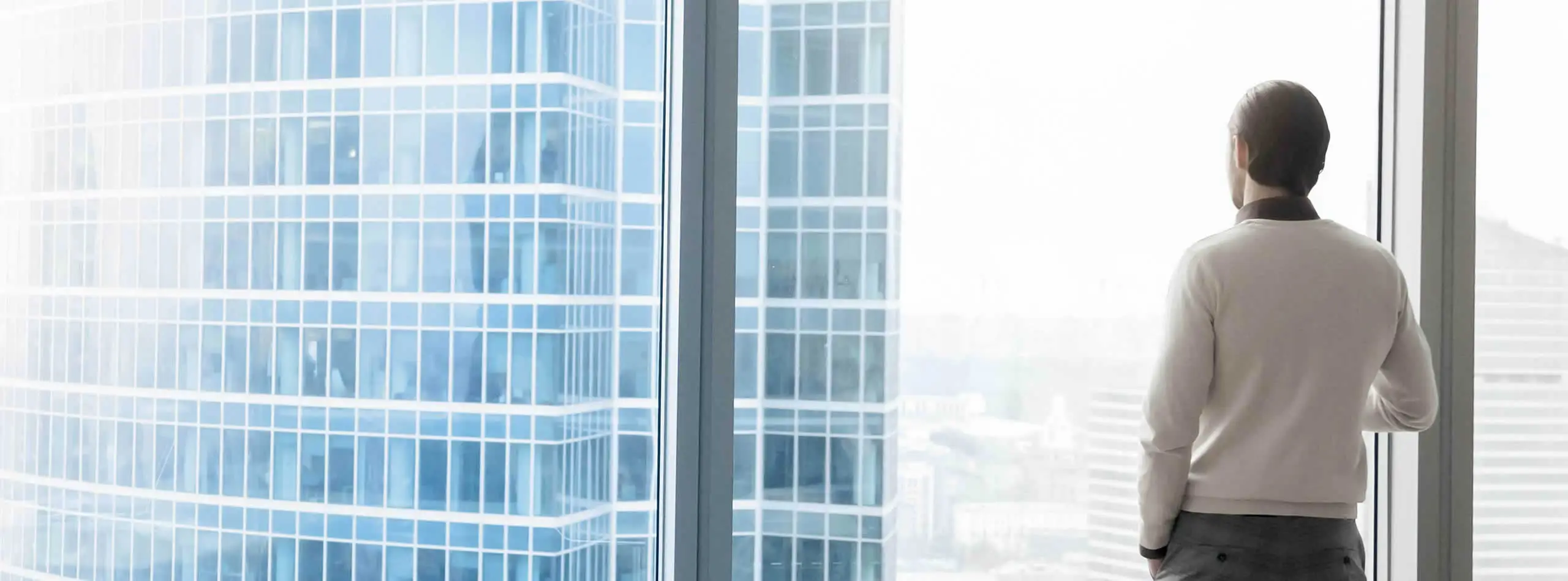 man looking at building