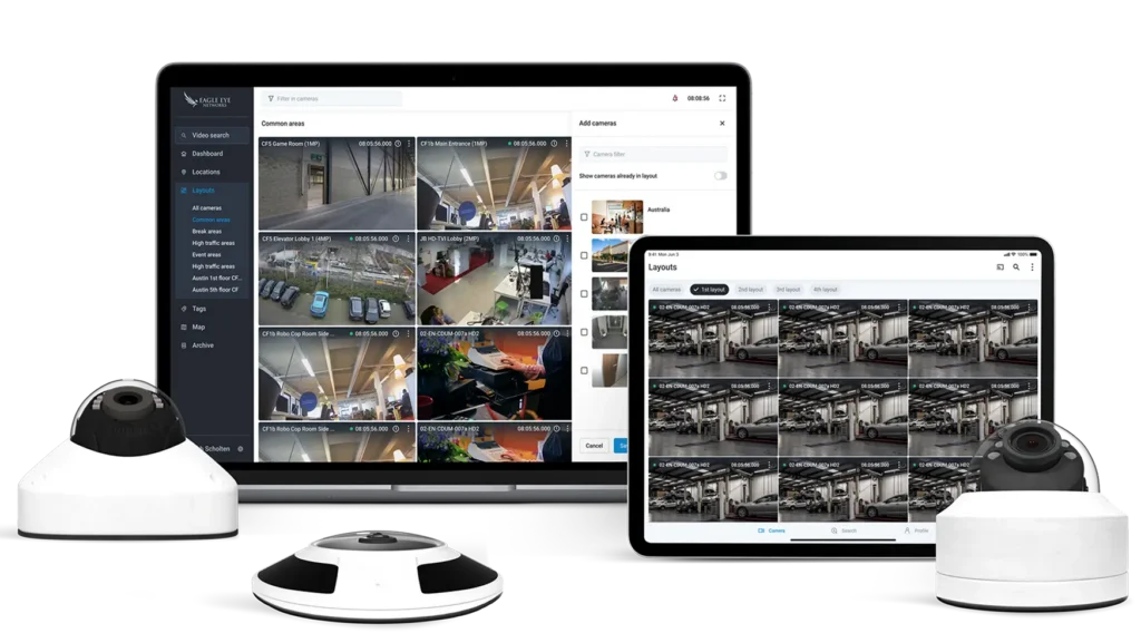 Surveillance dashboard showing multiple camera feeds on laptop and tablet with dome cameras in the foreground