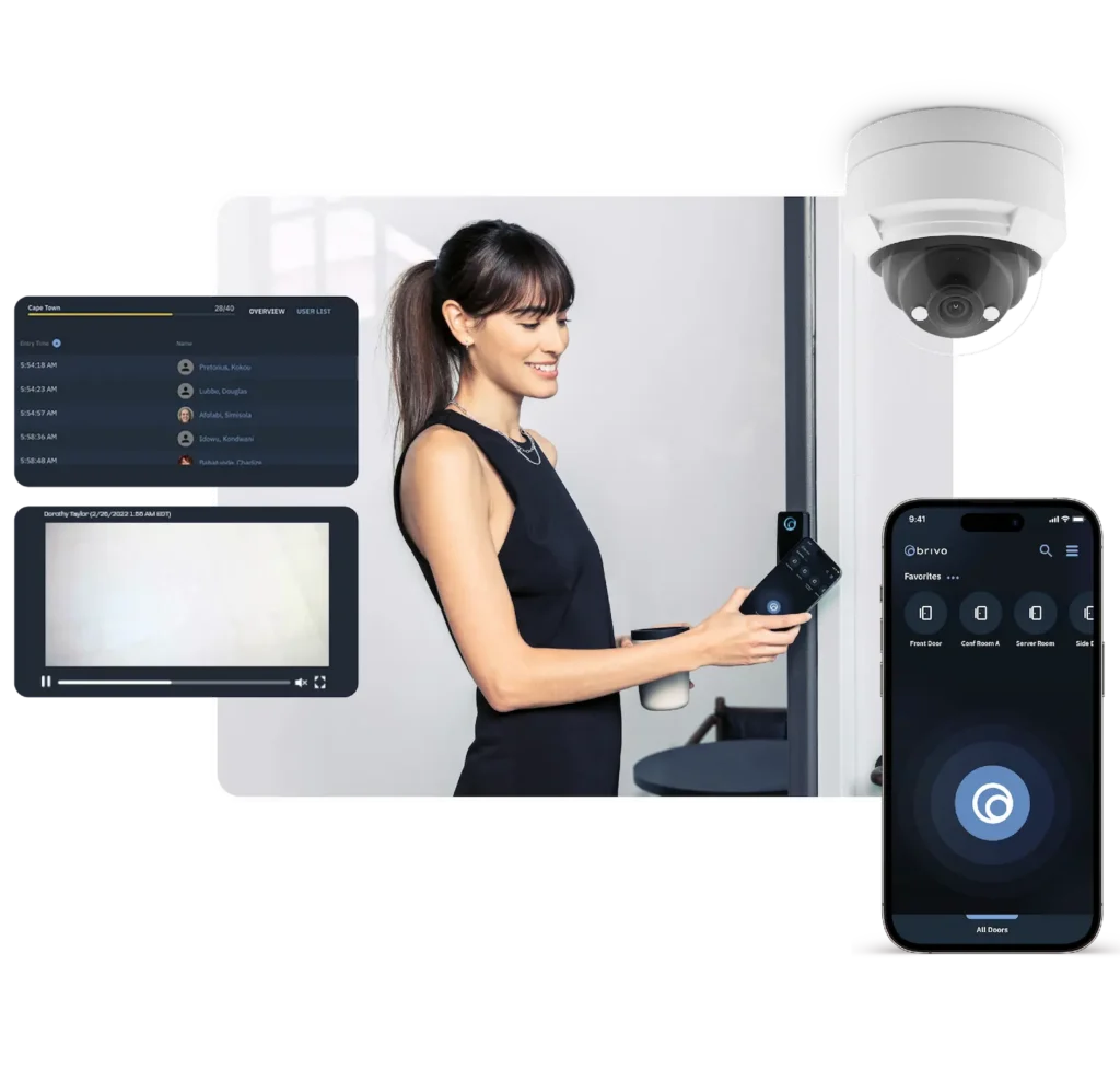Woman demonstrating a smart security system with a wall camera, monitoring screens, and a smartphone app interface.