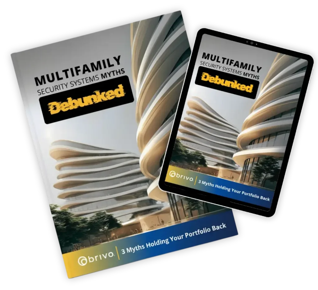Magazine and tablet displaying 'Multifamily Security Systems Myths: Debunked' with a futuristic building and Brivo branding, on a black background.