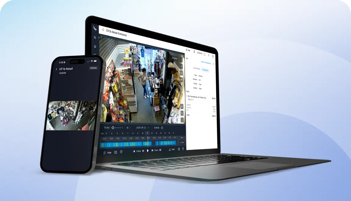 Laptop displaying a surveillance dashboard with multiple CCTV camera feeds, paired with a smartphone showing a live camera view nearby.