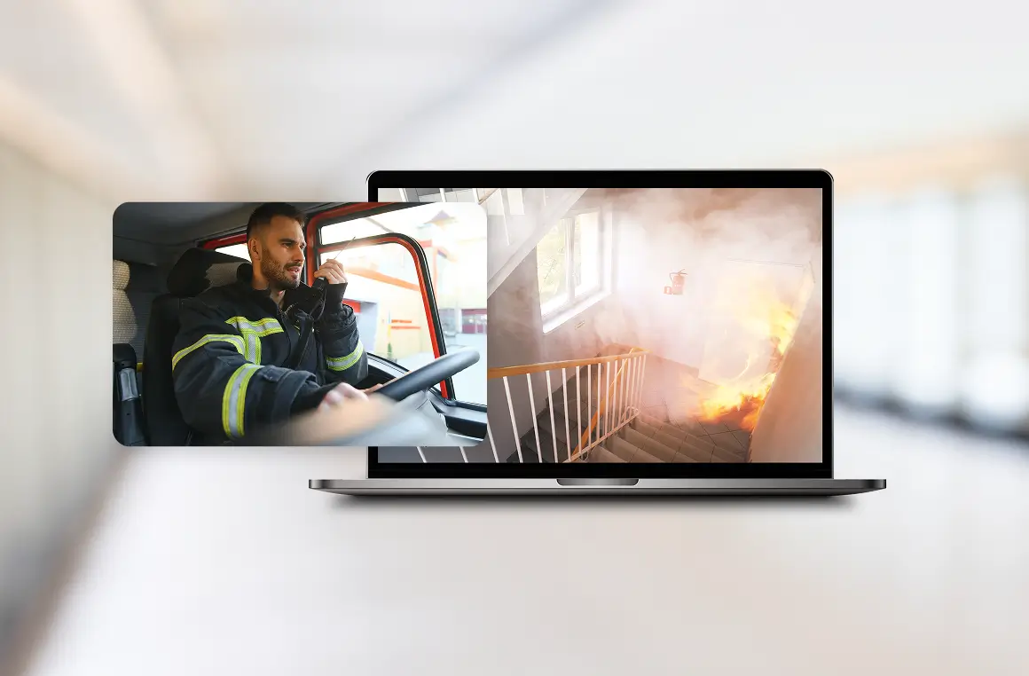 Laptop screen shows a split image: firefighter driving a vehicle on the left and a smoky burning interior on the right.